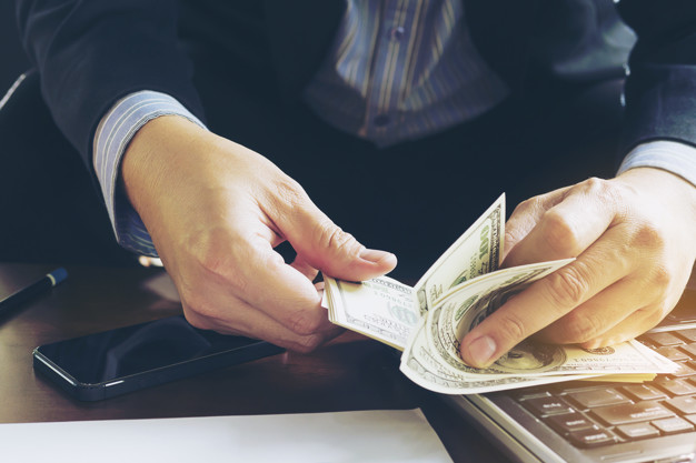 Business man counting dollar