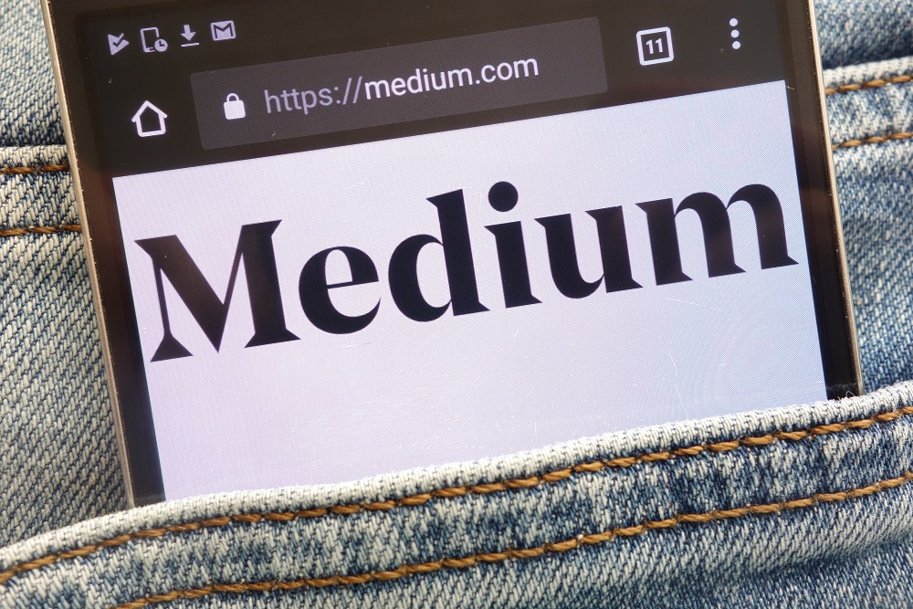 Medium website displayed on smartphone hidden in jeans pocket